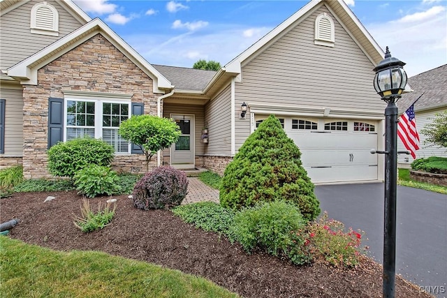 115 Shire Way, Camillus, NY 13031 - view of front of house featuring stone siding, asphalt driveway, and an attached garage
