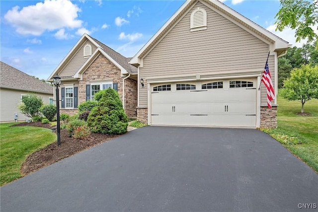 115 Shire Way, Camillus, NY 13031 - view of front of house with stone siding, driveway, a garage, and a front yard