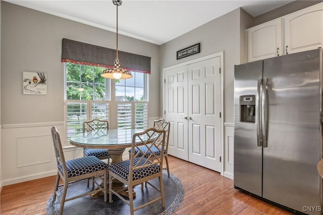 115 Shire Way, Camillus, NY 13031 - dining space with light wood-style floors and a wainscoted wall