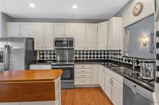 115 Shire Way, Camillus, NY 13031 - kitchen with stainless steel appliances, white cabinets, light wood-style flooring, backsplash, and recessed lighting