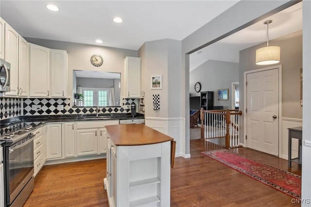 115 Shire Way, Camillus, NY 13031 - kitchen featuring stainless steel appliances, dark countertops, wood finished floors, backsplash, and white cabinetry