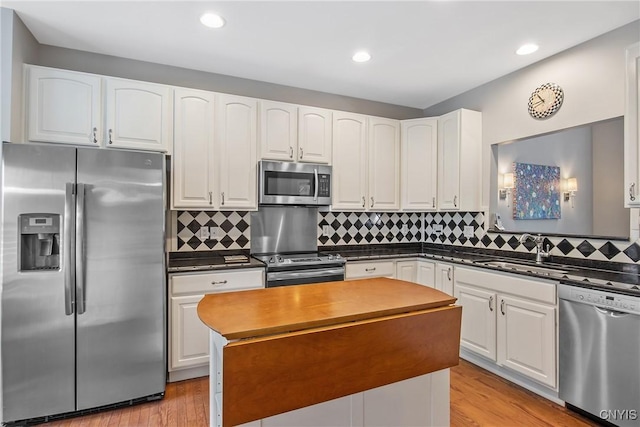 115 Shire Way, Camillus, NY 13031 - kitchen with stainless steel appliances, dark countertops, white cabinetry, a center island, and recessed lighting
