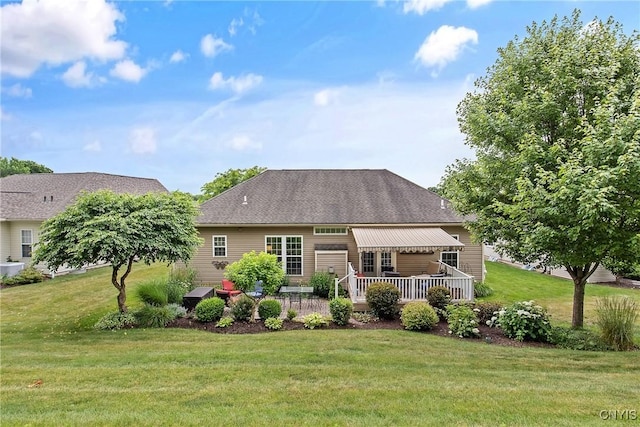 115 Shire Way, Camillus, NY 13031 - back of house featuring a yard, a wooden deck, and roof with shingles