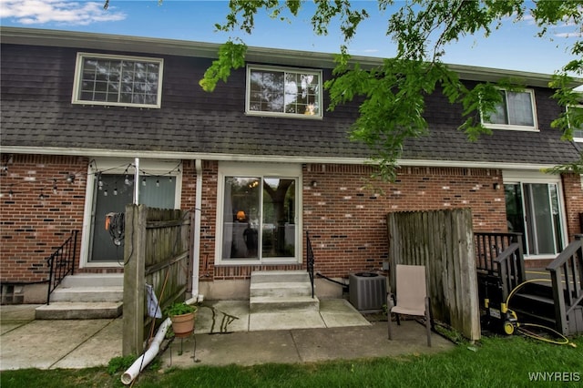 150 S Union Rd Unit 123, Amherst, NY 14221 - rear view of property featuring entry steps, a shingled roof, brick siding, and a patio area