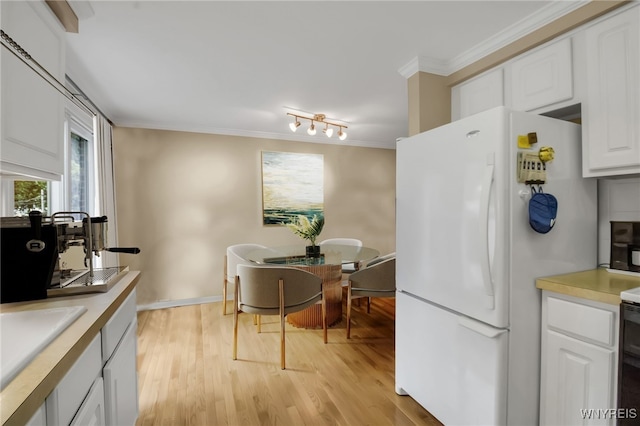 150 S Union Rd Unit 123, Amherst, NY 14221 - kitchen with freestanding refrigerator, crown molding, light wood finished floors, white cabinets, and light countertops