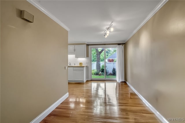 150 S Union Rd Unit 123, Amherst, NY 14221 - unfurnished living room featuring light wood-type flooring and crown molding