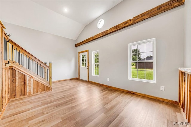 10655 Millers Rd, Yates, NY 14098 - unfurnished living room with wood finished floors, lofted ceiling, and stairway