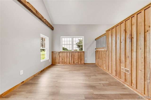 10655 Millers Rd, Yates, NY 14098 - unfurnished room featuring lofted ceiling, plenty of natural light, and light wood-style flooring