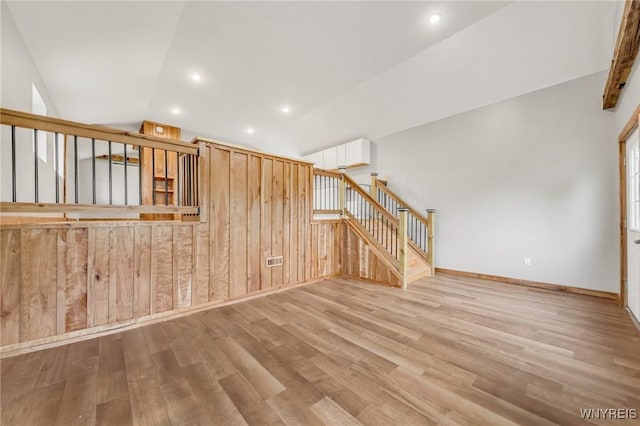 10655 Millers Rd, Yates, NY 14098 - unfurnished room featuring stairway, wood finished floors, lofted ceiling, and recessed lighting