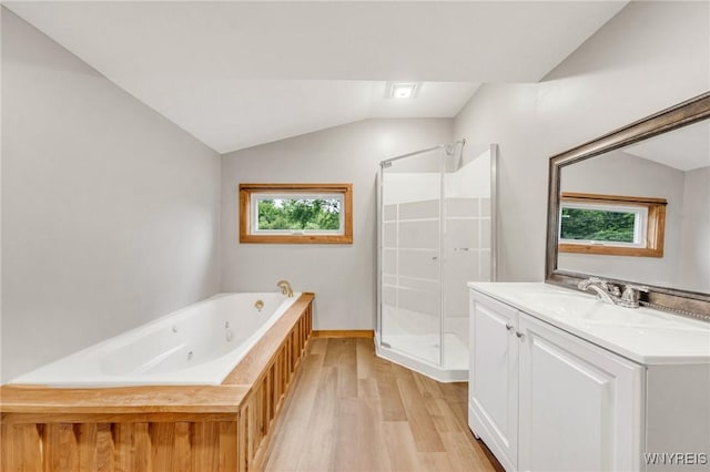 10655 Millers Rd, Yates, NY 14098 - bathroom featuring wood finished floors, a stall shower, lofted ceiling, a whirlpool tub, and vanity