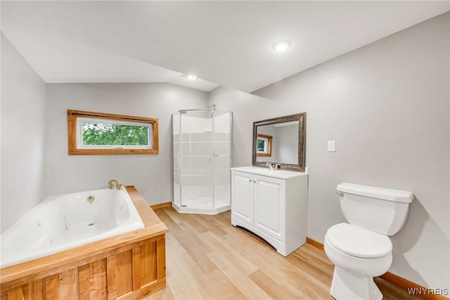 10655 Millers Rd, Yates, NY 14098 - bathroom featuring vanity, a shower stall, wood finished floors, a tub with jets, and lofted ceiling