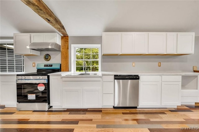 10655 Millers Rd, Yates, NY 14098 - kitchen with stainless steel appliances, exhaust hood, light wood-style flooring, light countertops, and beam ceiling