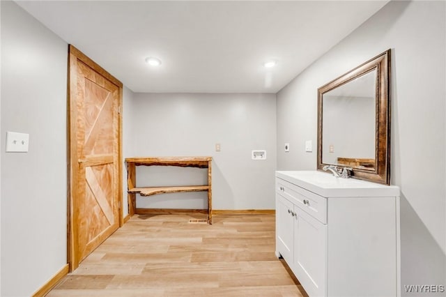 10655 Millers Rd, Yates, NY 14098 - bathroom featuring vanity, wood finished floors, and recessed lighting