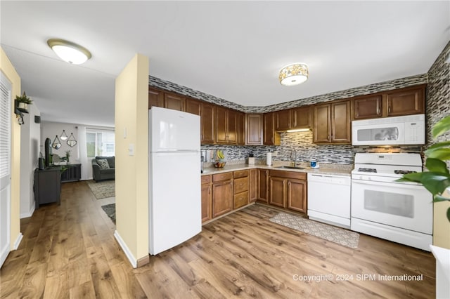 35 Stoneledge, Amherst, NY 14221 - kitchen featuring white appliances, light countertops, light wood finished floors, and backsplash