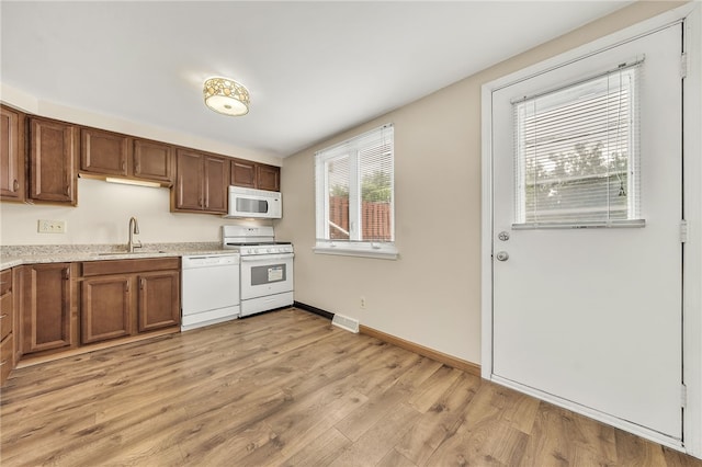 35 Stoneledge, Amherst, NY 14221 - kitchen with white appliances, light wood finished floors, and brown cabinets