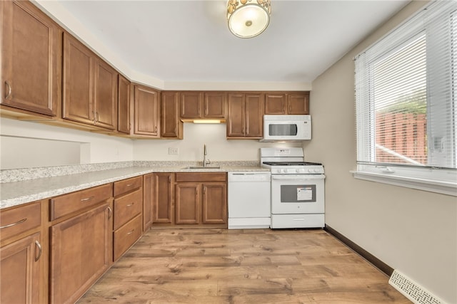 35 Stoneledge, Amherst, NY 14221 - kitchen featuring white appliances, brown cabinets, light wood-style flooring, and light countertops
