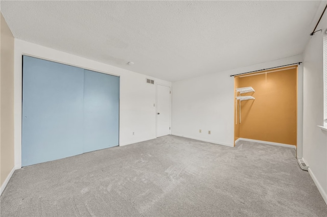 35 Stoneledge, Amherst, NY 14221 - unfurnished bedroom with a closet, carpet flooring, and a textured ceiling
