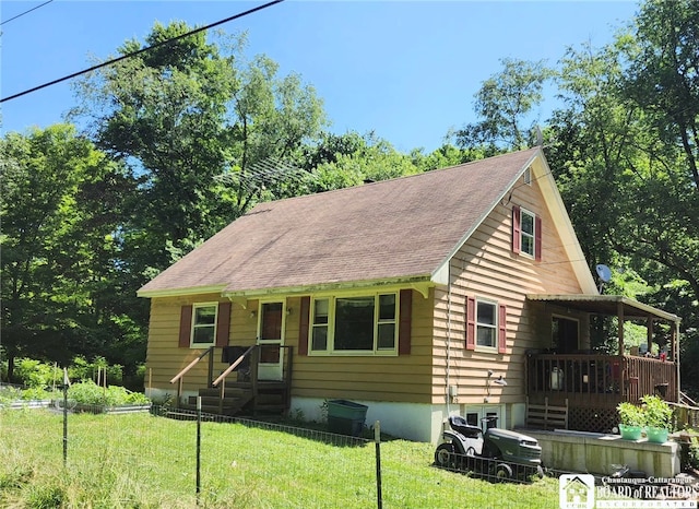 960 Peterson Rd, Carroll, NY 14738 - view of front of property featuring a front lawn, a shingled roof, and a deck