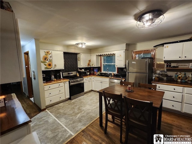 960 Peterson Rd, Carroll, NY 14738 - kitchen featuring stainless steel appliances, white cabinetry, wood finished floors, and dark countertops