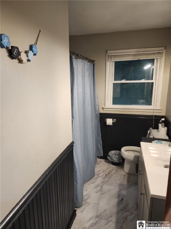 960 Peterson Rd, Carroll, NY 14738 - full bath featuring marble look tile flooring, vanity, wainscoting, and a shower with shower curtain