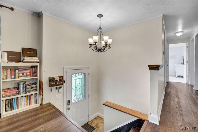 1218 Baseline Rd, Grand Island, NY 14072 - entryway featuring a chandelier, wood finished floors, crown molding, and a textured ceiling