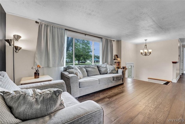 1218 Baseline Rd, Grand Island, NY 14072 - living room featuring a textured ceiling, a chandelier, and wood finished floors