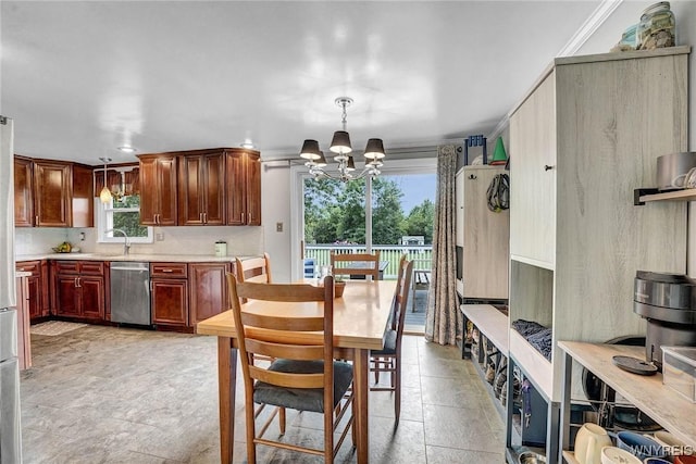 1218 Baseline Rd, Grand Island, NY 14072 - kitchen with stainless steel dishwasher, a chandelier, light countertops, decorative light fixtures, and ornamental molding