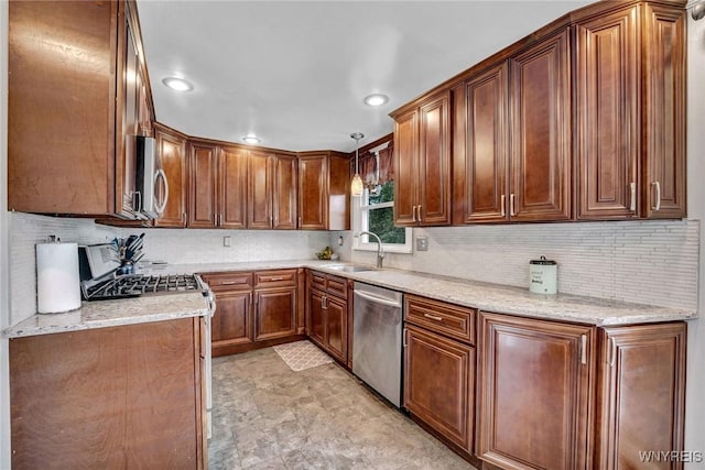 1218 Baseline Rd, Grand Island, NY 14072 - kitchen with appliances with stainless steel finishes, tasteful backsplash, recessed lighting, hanging light fixtures, and brown cabinets