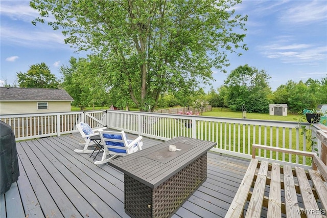 1218 Baseline Rd, Grand Island, NY 14072 - wooden deck featuring a lawn, a storage unit, and view of wooded area