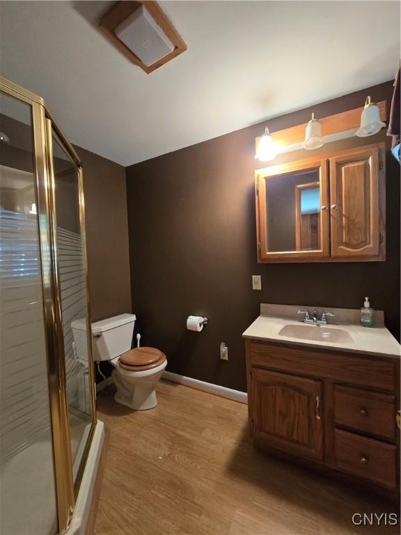 4777 Glencrest Ave, Clay, NY 13088 - bathroom with vanity, a shower stall, and wood finished floors