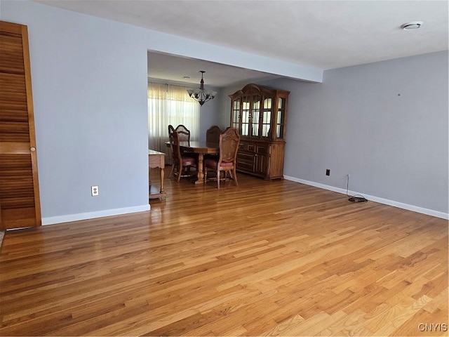 4777 Glencrest Ave, Clay, NY 13088 - spare room featuring a chandelier and light wood-style flooring