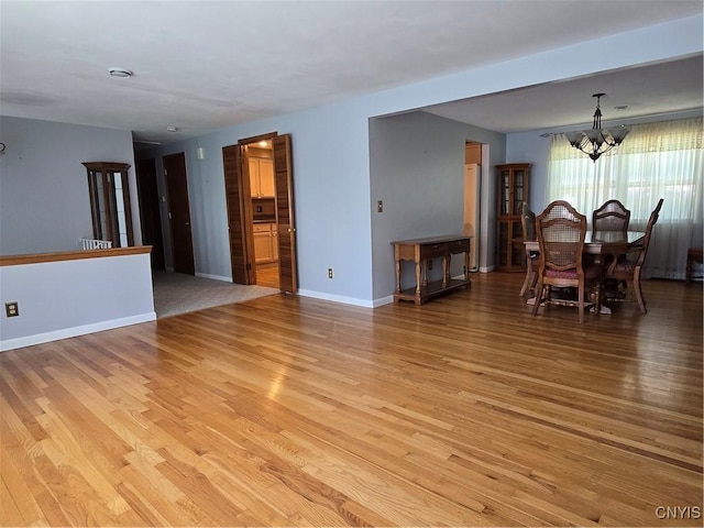 4777 Glencrest Ave, Clay, NY 13088 - dining area with a chandelier and light wood-style flooring