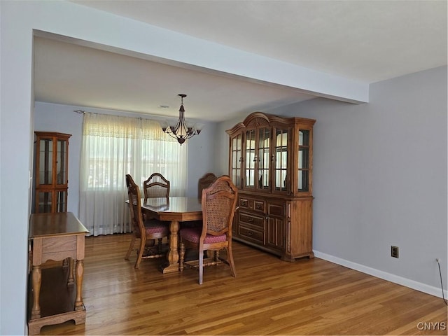 4777 Glencrest Ave, Clay, NY 13088 - dining room featuring a chandelier, light wood-type flooring, and beam ceiling