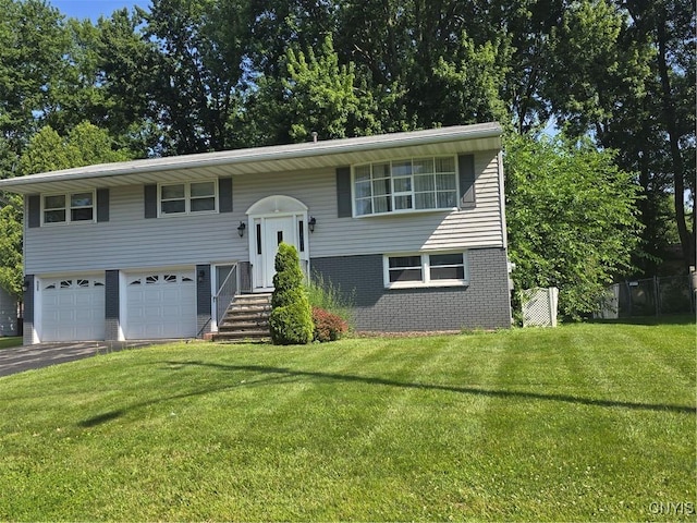 4777 Glencrest Ave, Clay, NY 13088 - split foyer home featuring asphalt driveway, an attached garage, and brick siding