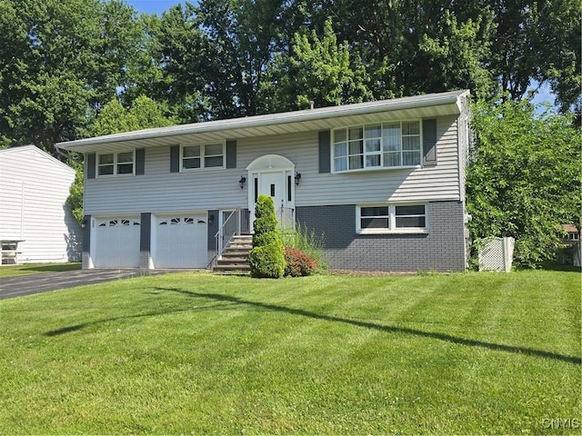 4777 Glencrest Ave, Clay, NY 13088 - split foyer home with asphalt driveway, a garage, a front yard, and brick siding