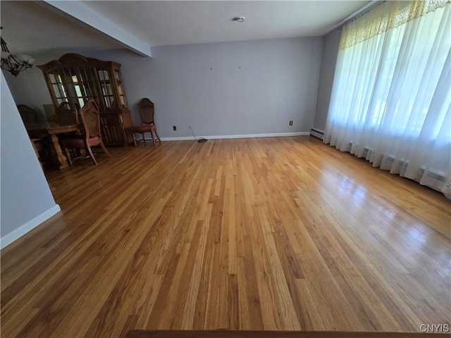 4777 Glencrest Ave, Clay, NY 13088 - unfurnished living room with wood finished floors and a baseboard radiator