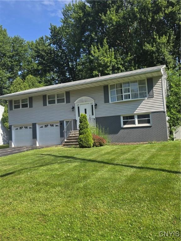 4777 Glencrest Ave, Clay, NY 13088 - bi-level home with a garage, asphalt driveway, and a front yard