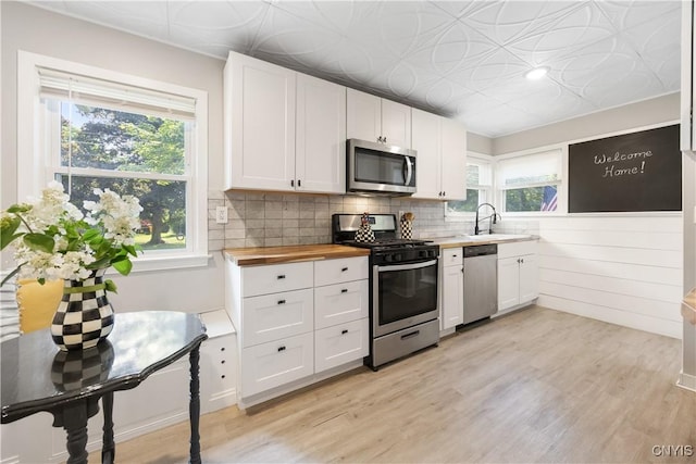 200 Audubon Rd, Manlius, NY 13066 - kitchen featuring stainless steel appliances, wooden counters, white cabinetry, light wood finished floors, and an ornate ceiling