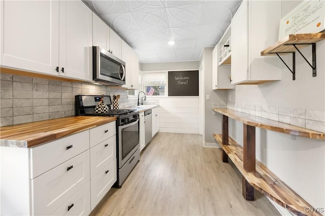 200 Audubon Rd, Manlius, NY 13066 - kitchen with appliances with stainless steel finishes, wooden counters, open shelves, light wood finished floors, and white cabinets