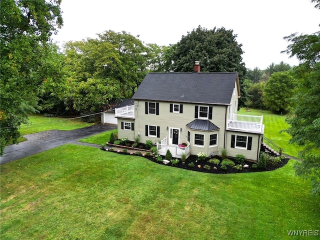 10448 Clarence Center Rd, Clarence, NY 14031 - colonial inspired home with a balcony, a front lawn, stairs, a chimney, and view of wooded area