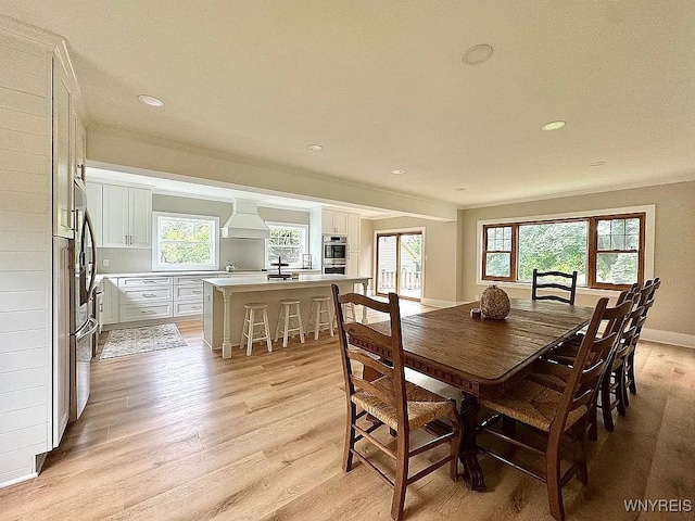 10448 Clarence Center Rd, Clarence, NY 14031 - dining area with light wood-style flooring, recessed lighting, and crown molding