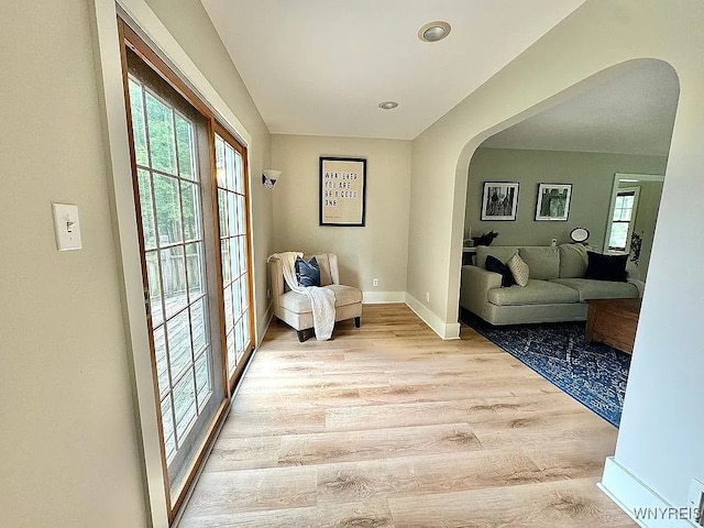 10448 Clarence Center Rd, Clarence, NY 14031 - living area featuring arched walkways and light wood-style floors