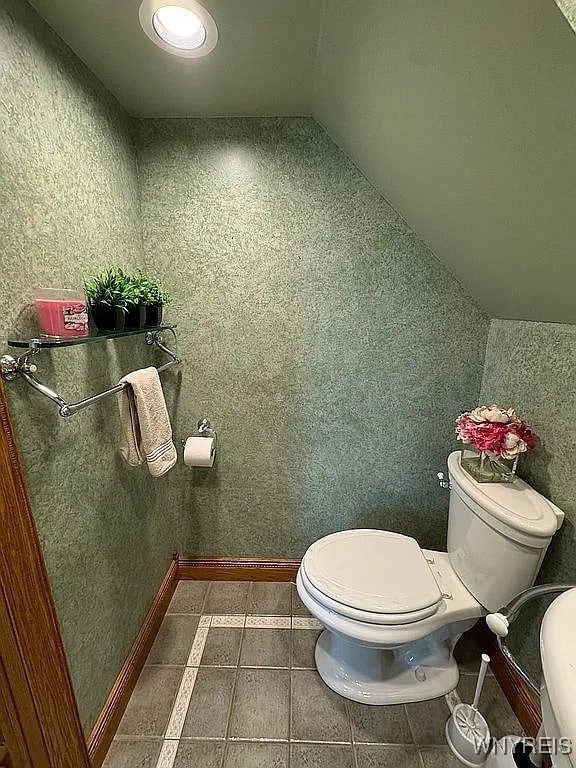 10448 Clarence Center Rd, Clarence, NY 14031 - bathroom featuring toilet and lofted ceiling