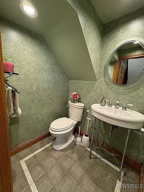 10448 Clarence Center Rd, Clarence, NY 14031 - half bath featuring lofted ceiling and tile patterned flooring