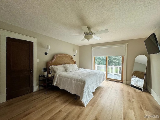 10448 Clarence Center Rd, Clarence, NY 14031 - bedroom with access to outside, light wood-style floors, a textured ceiling, and a ceiling fan