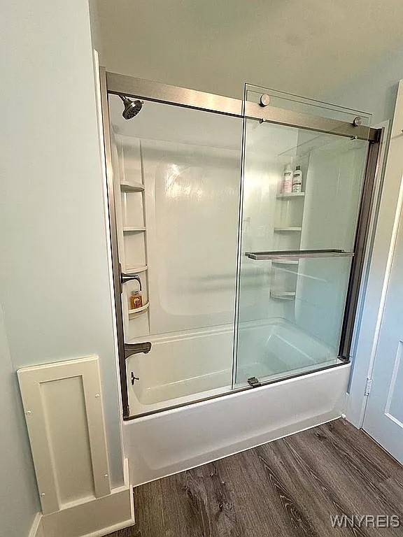 10448 Clarence Center Rd, Clarence, NY 14031 - bathroom featuring shower / bath combination with glass door and wood finished floors