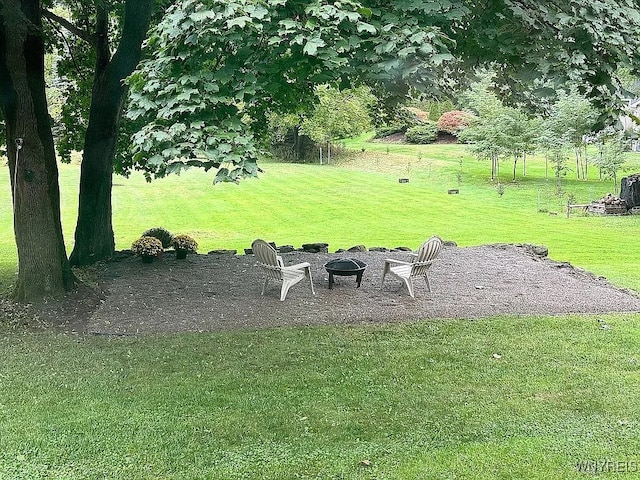 10448 Clarence Center Rd, Clarence, NY 14031 - view of grassy yard with an outdoor fire pit