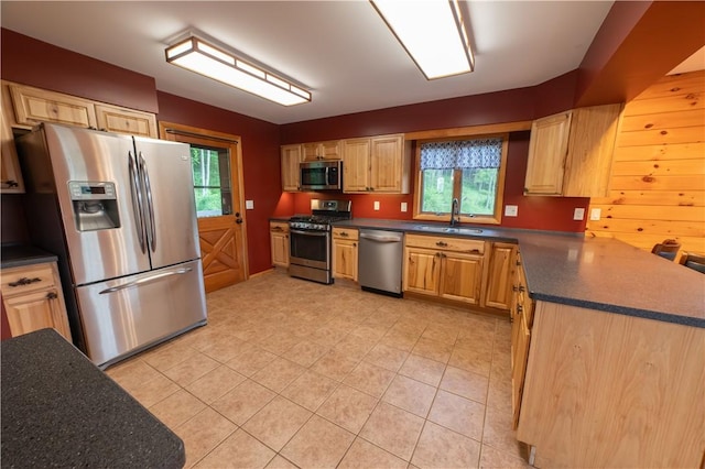 817 Flax Island Rd, Otego, NY 13825 - kitchen featuring stainless steel appliances, dark countertops, light tile patterned floors, and light brown cabinets
