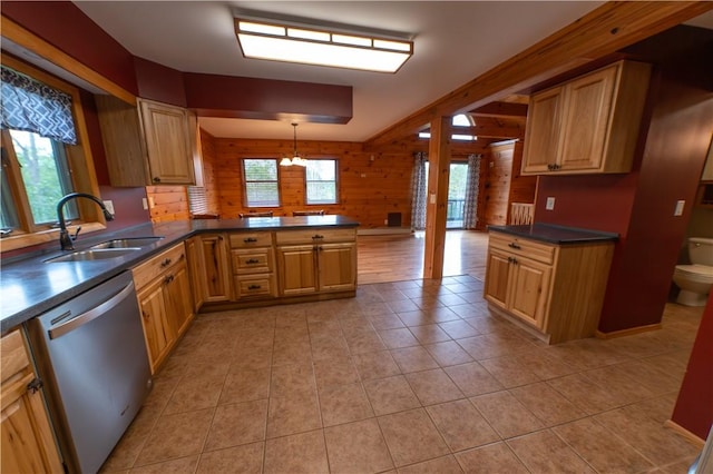 817 Flax Island Rd, Otego, NY 13825 - kitchen featuring stainless steel dishwasher, wooden walls, dark countertops, light tile patterned floors, and a peninsula
