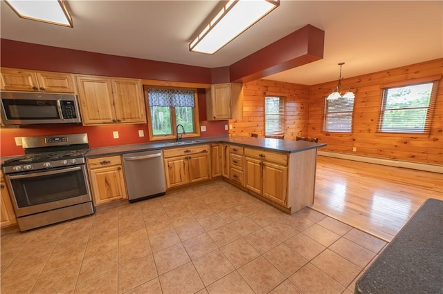 817 Flax Island Rd, Otego, NY 13825 - kitchen with appliances with stainless steel finishes, dark countertops, a peninsula, light tile patterned flooring, and wood walls